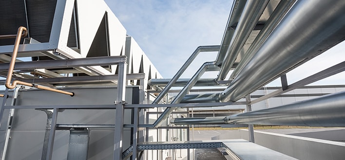 Intricate commercial air conditioning system and ductwork outside of a commercial building